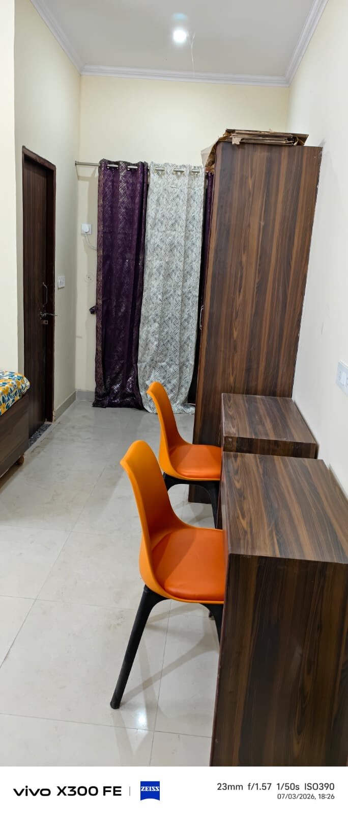 Hostel room with wardrobe, study tables and balcony access