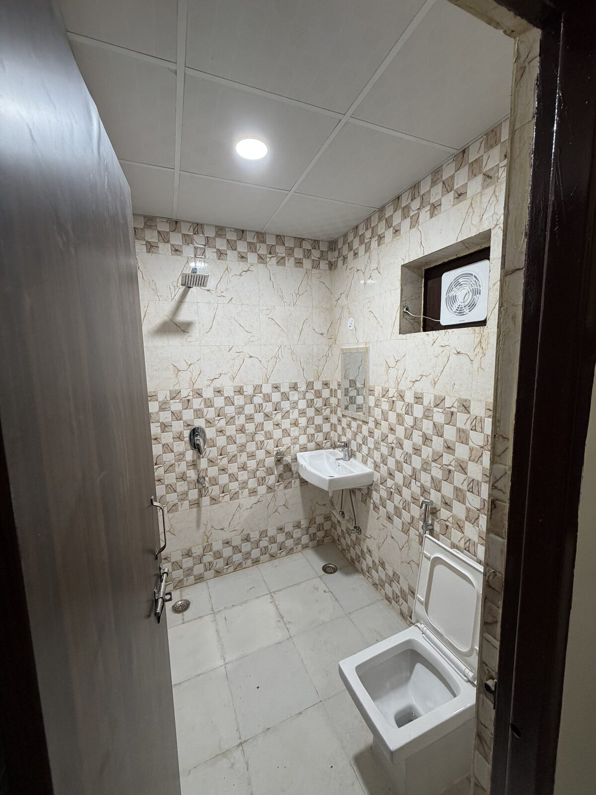 Clean tiled attached washroom